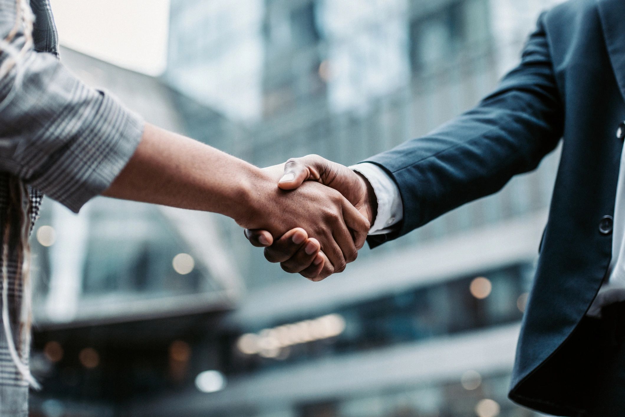Two business professionals shaking hands representing partnership