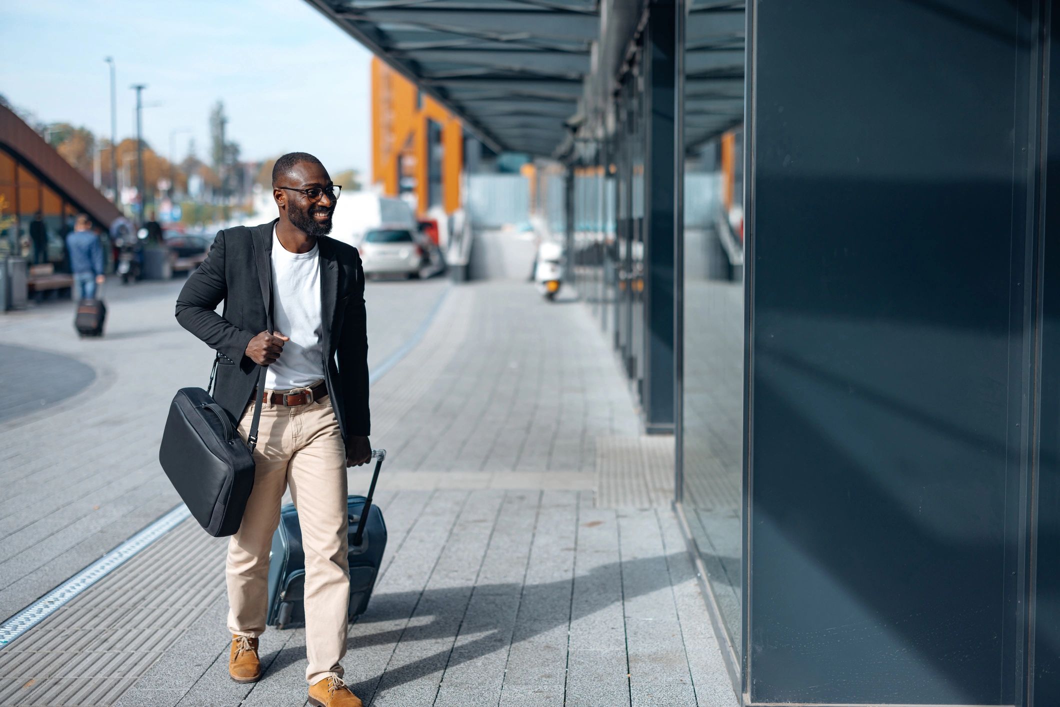 Business traveler with suitcase near an airport